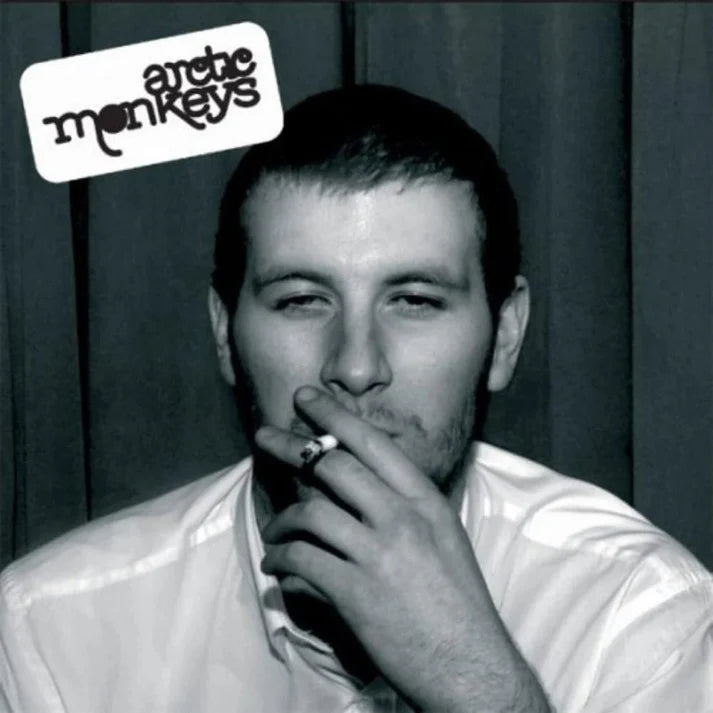 Black and white album cover with a man smoking, featuring the Arctic Monkeys logo.