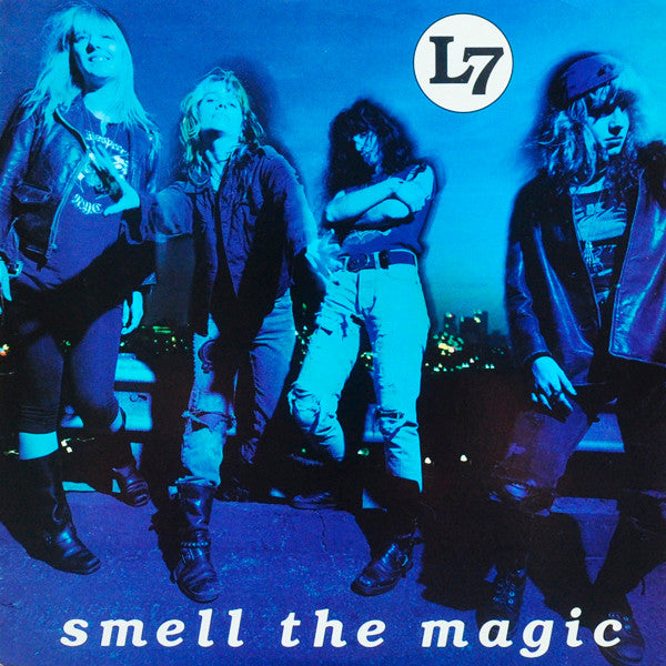 Album cover with a band posing and 'L7' logo, text 'smell the magic' on blue background