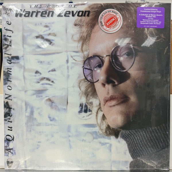 Vinyl record cover with a portrait of a person wearing glasses and text about Warren Zevon.