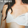 Album cover art for 'The Beaches' featuring a close-up of a woman wearing a white bra with 'no hard feelings' written on it. The text 'THE BEACHES' is visible in the top left, and a 'Parental Advisory' label is in the bottom right.