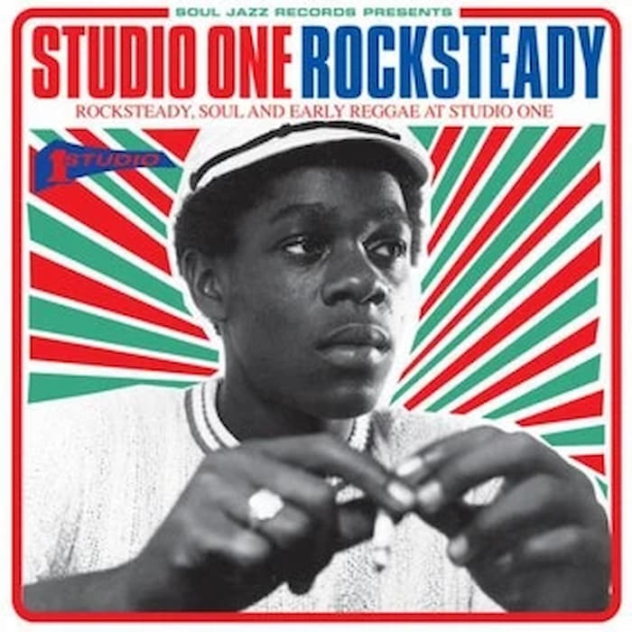 Album cover for 'Studio One Rocksteady' with a person wearing a cap and striped background.