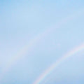 Partial rainbow in a light blue sky