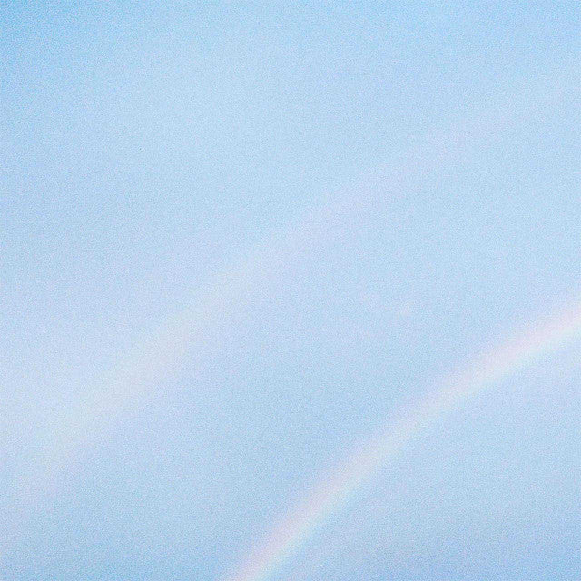 Partial rainbow in a light blue sky